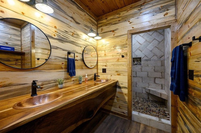 bathroom featuring wooden walls, hardwood / wood-style flooring, a shower, vanity, and wood ceiling