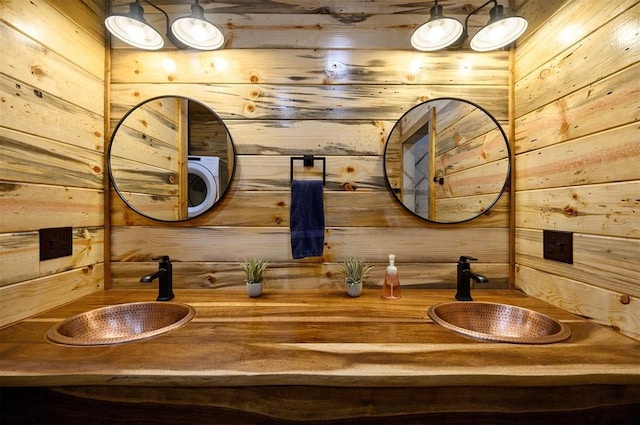 bathroom featuring wooden walls and vanity