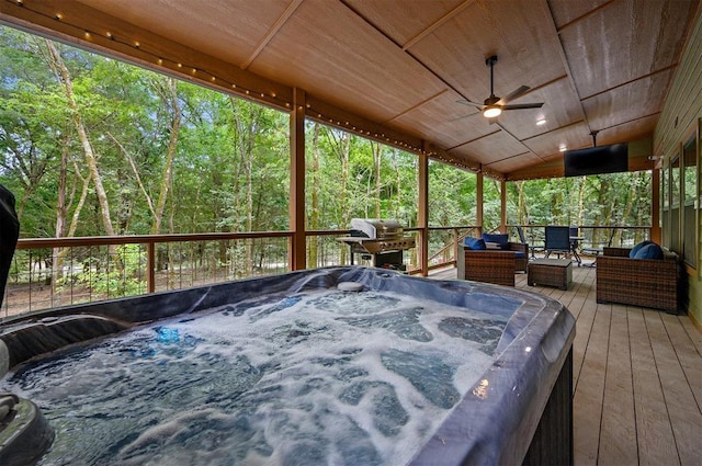 deck featuring ceiling fan, a hot tub, and area for grilling