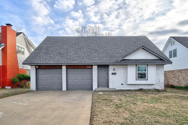 view of front of property with a front lawn and a garage