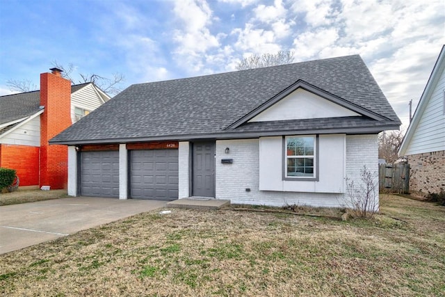 view of front of house with a front yard and a garage