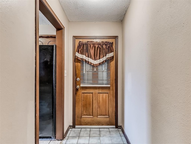 doorway with a textured ceiling