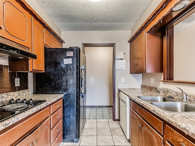 kitchen with sink, a textured ceiling, black appliances, and light tile patterned flooring