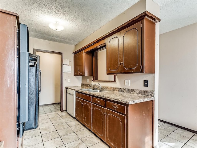 kitchen featuring white dishwasher, sink, and dark brown cabinetry