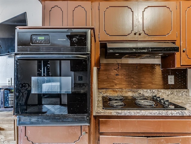 kitchen with tasteful backsplash and black electric stovetop