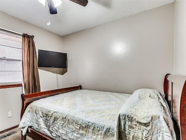 bedroom featuring ceiling fan and a textured ceiling