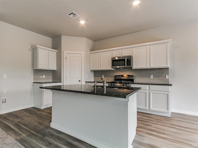 13156 Mannington Rd, Edmond, OK 73025 - kitchen with stainless steel appliances, tasteful backsplash, white cabinetry, and recessed lighting
