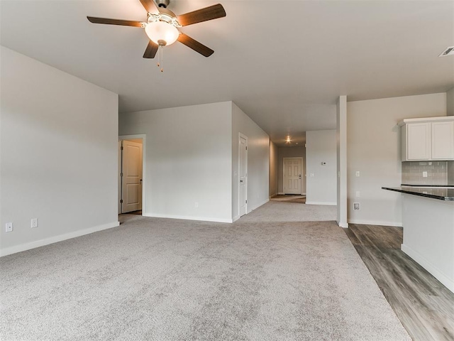 13156 Mannington Rd, Edmond, OK 73025 - unfurnished living room featuring a ceiling fan, baseboards, and carpet