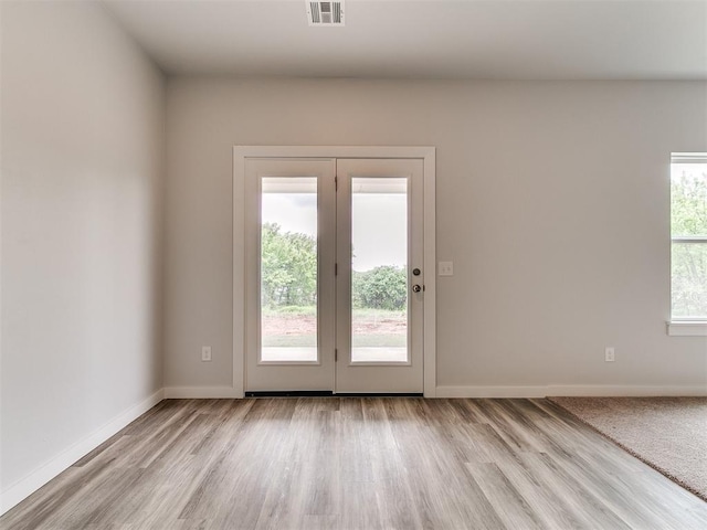 13156 Mannington Rd, Edmond, OK 73025 - doorway featuring light wood-style flooring and baseboards