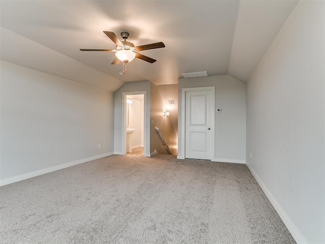 13156 Mannington Rd, Edmond, OK 73025 - unfurnished bedroom with carpet flooring, lofted ceiling, ensuite bath, baseboards, and ceiling fan