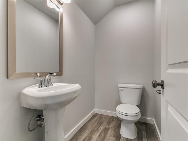 13156 Mannington Rd, Edmond, OK 73025 - half bath with toilet, lofted ceiling, baseboards, and wood finished floors