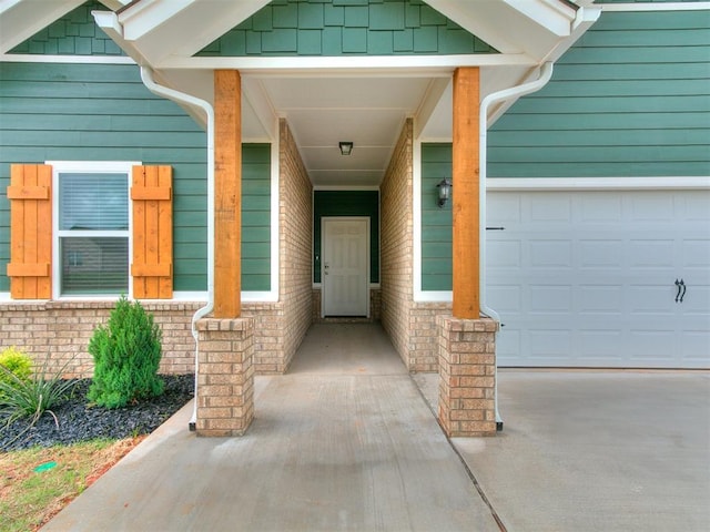 13156 Mannington Rd, Edmond, OK 73025 - doorway to property with concrete driveway, an attached garage, and brick siding