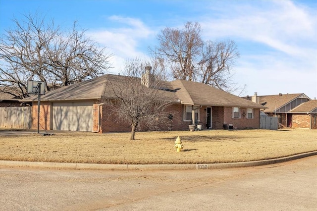 ranch-style house featuring a front yard and a garage