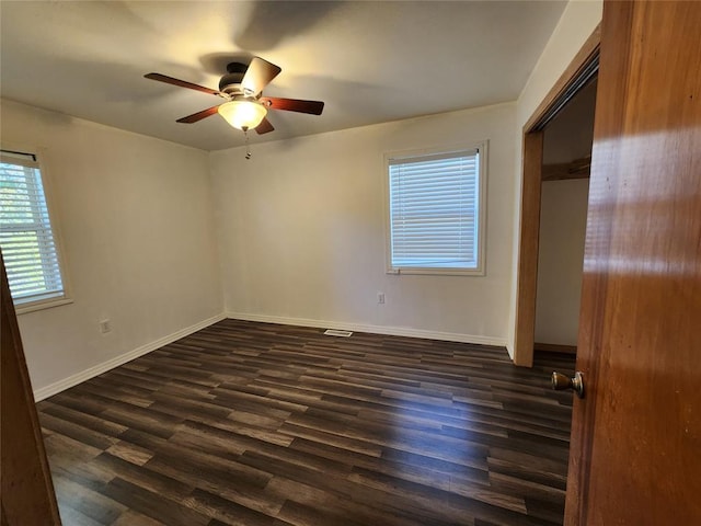 unfurnished bedroom featuring a closet, ceiling fan, and dark hardwood / wood-style flooring