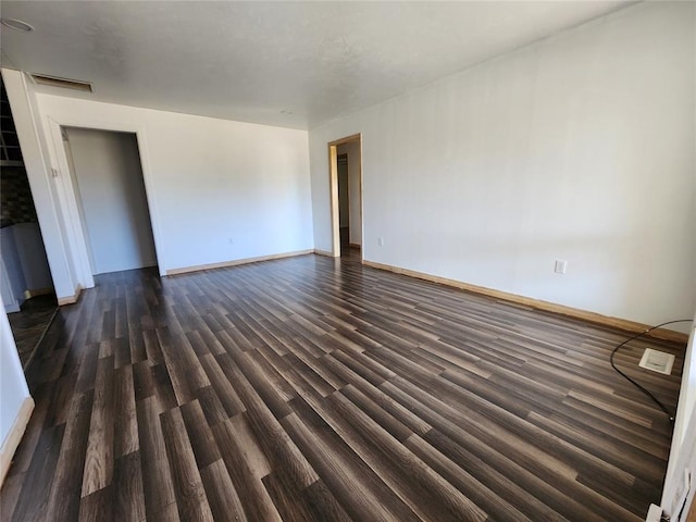 spare room with dark hardwood / wood-style flooring