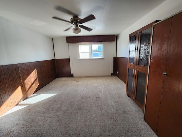 spare room featuring ceiling fan and light colored carpet