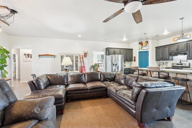 living area with ceiling fan, finished concrete floors, and recessed lighting