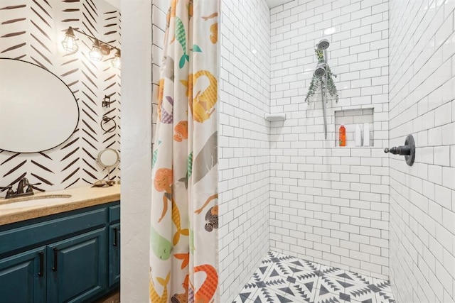 bathroom featuring a tile shower and vanity