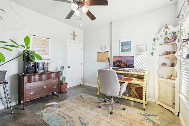 office area with ceiling fan and baseboards