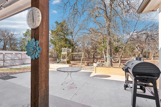 view of patio / terrace featuring a playground and area for grilling