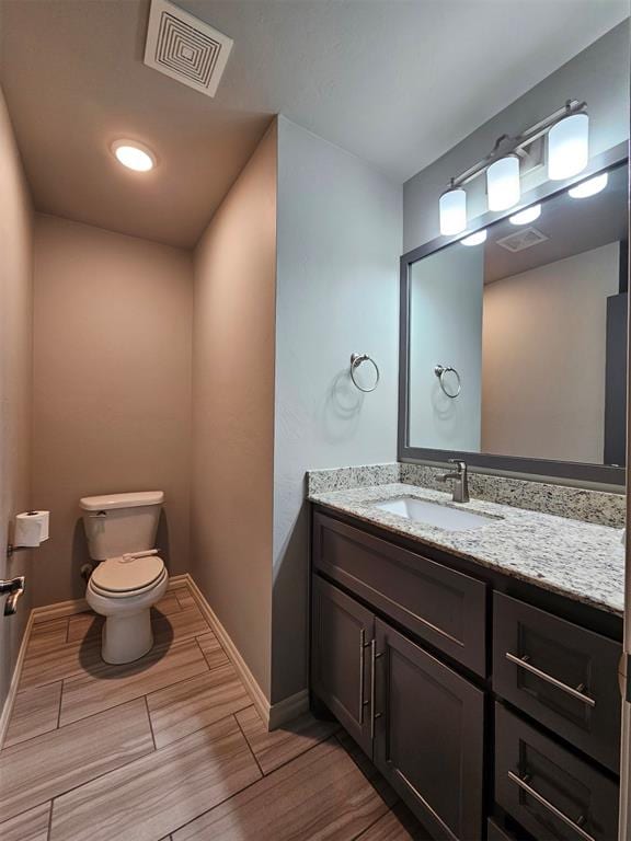 bathroom with toilet and vanity