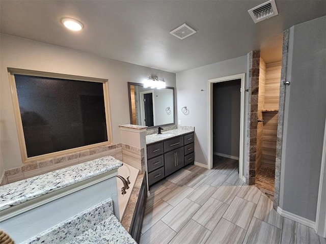 bathroom featuring shower with separate bathtub and vanity