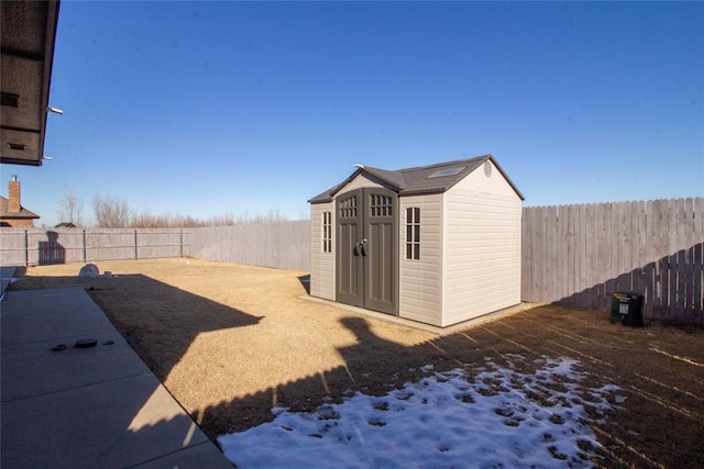 snowy yard with a storage unit