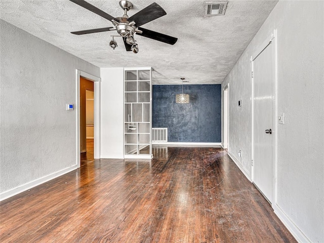 unfurnished living room featuring dark hardwood / wood-style flooring and ceiling fan