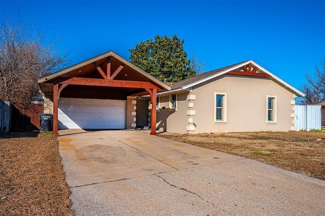 ranch-style house featuring a garage and a carport