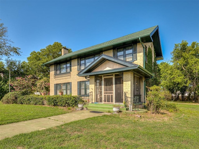 view of front of property featuring a sunroom and a front yard