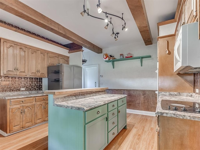 kitchen featuring light hardwood / wood-style floors, a center island, beamed ceiling, stainless steel fridge, and green cabinets