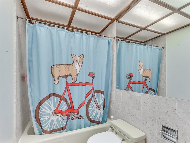 bathroom featuring shower / bath combo with shower curtain and toilet