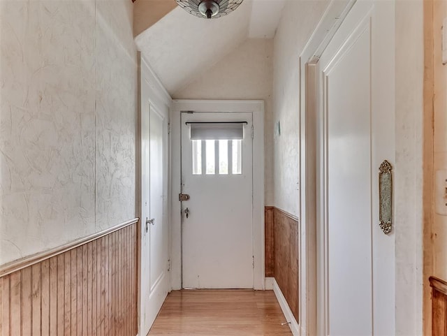 entryway with vaulted ceiling and wood-type flooring