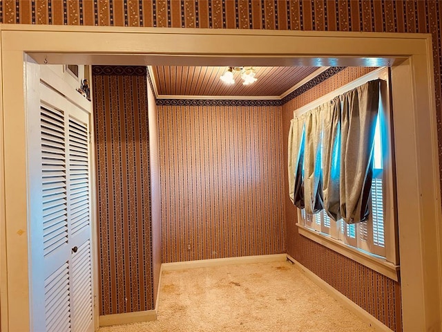 interior space with wood ceiling and carpet