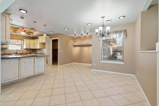 kitchen featuring pendant lighting, a chandelier, light tile patterned flooring, and decorative backsplash