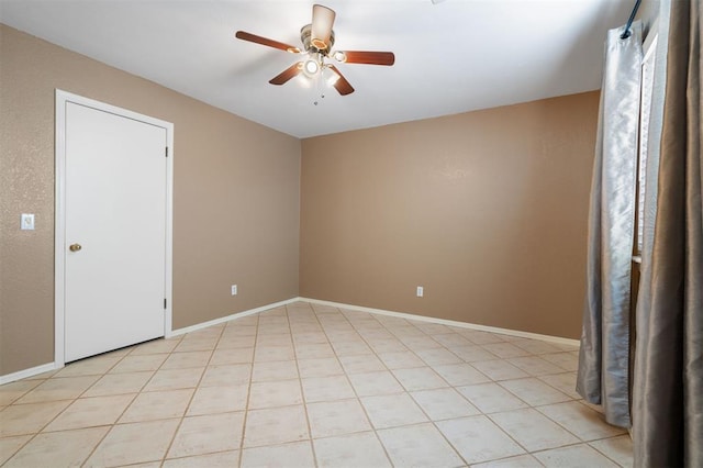 tiled empty room featuring ceiling fan