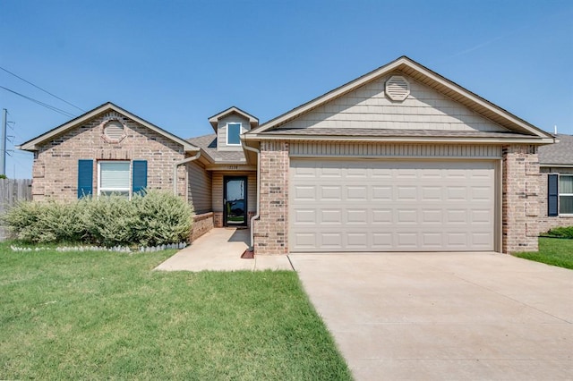 view of front of house with a front yard and a garage