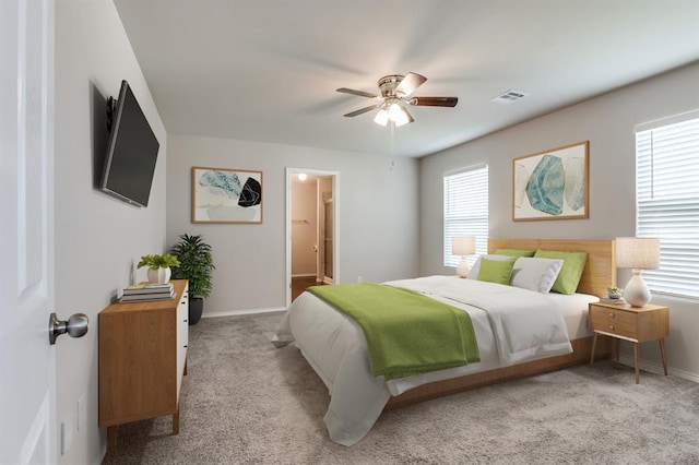 carpeted bedroom featuring ceiling fan and ensuite bathroom