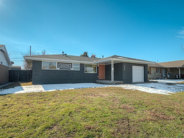 ranch-style home with a front yard and a garage