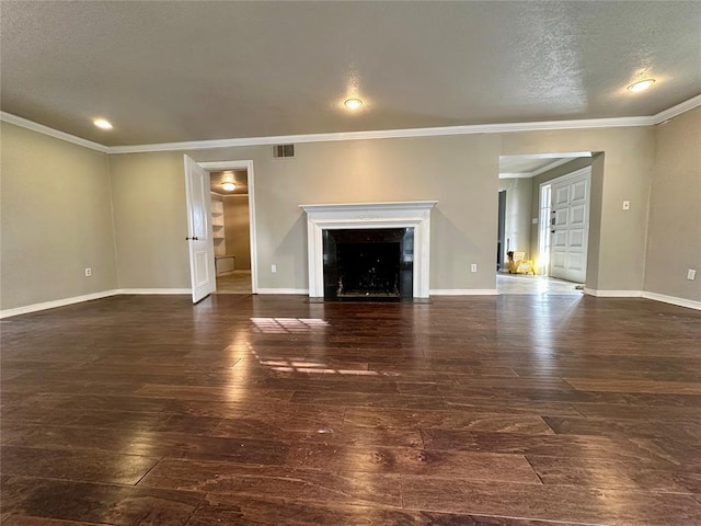 unfurnished living room featuring ornamental molding, dark hardwood / wood-style flooring, and a textured ceiling