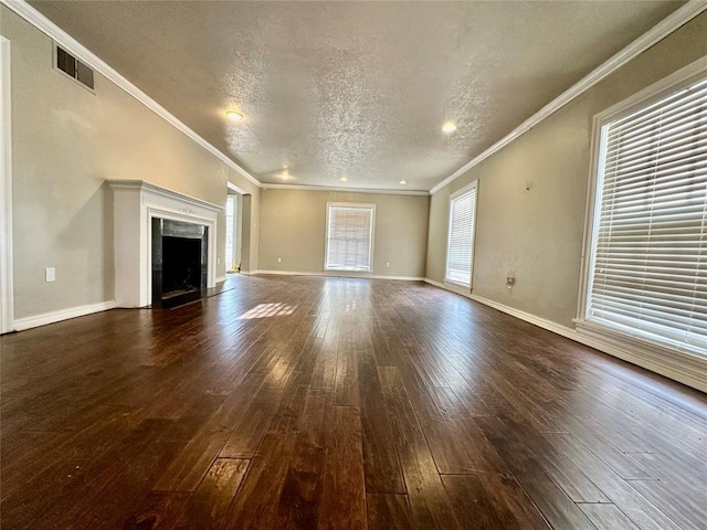 unfurnished living room featuring a textured ceiling, ornamental molding, and dark hardwood / wood-style floors