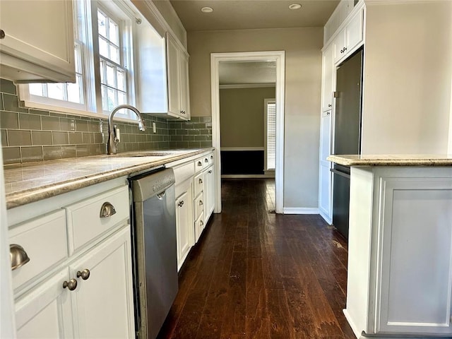 kitchen with dishwasher, light stone countertops, dark hardwood / wood-style flooring, sink, and white cabinetry