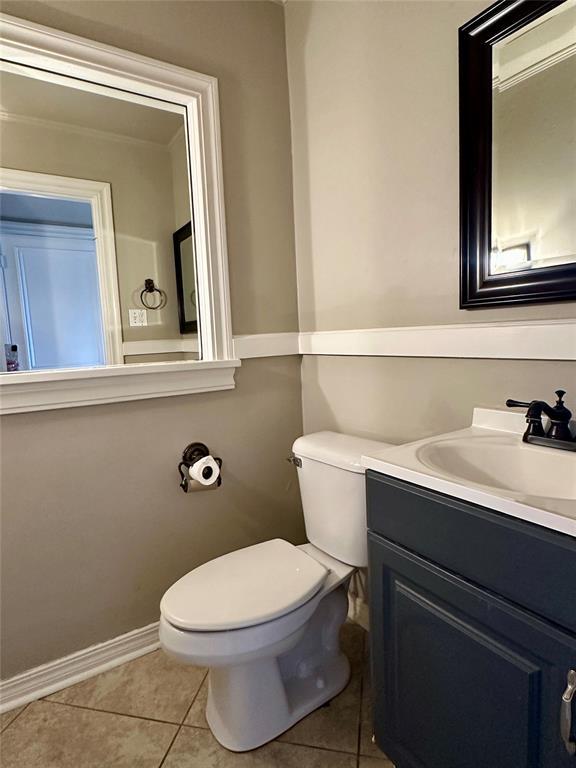 bathroom featuring toilet, tile patterned floors, and vanity