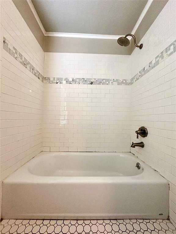 bathroom featuring tile patterned floors, shower / tub combination, and crown molding