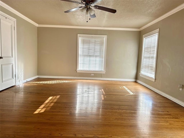 spare room with ceiling fan, crown molding, a textured ceiling, and wood-type flooring