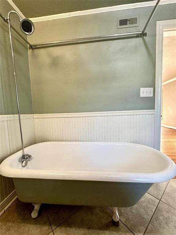 bathroom featuring tile patterned floors and a tub to relax in