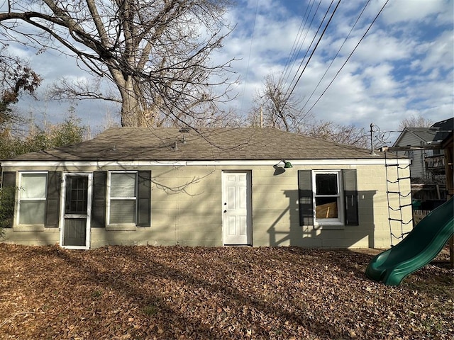 back of house featuring a playground