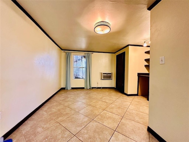 tiled empty room with a wall mounted AC and crown molding