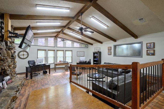 living room featuring ceiling fan, a textured ceiling, hardwood / wood-style flooring, and lofted ceiling with beams