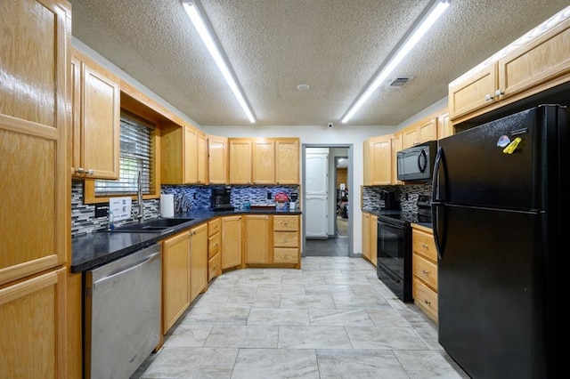 kitchen featuring light brown cabinetry, sink, backsplash, and black appliances